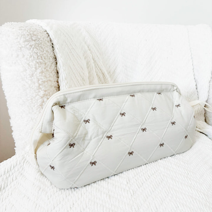 Quilted makeup organizer bag with feminine bow print