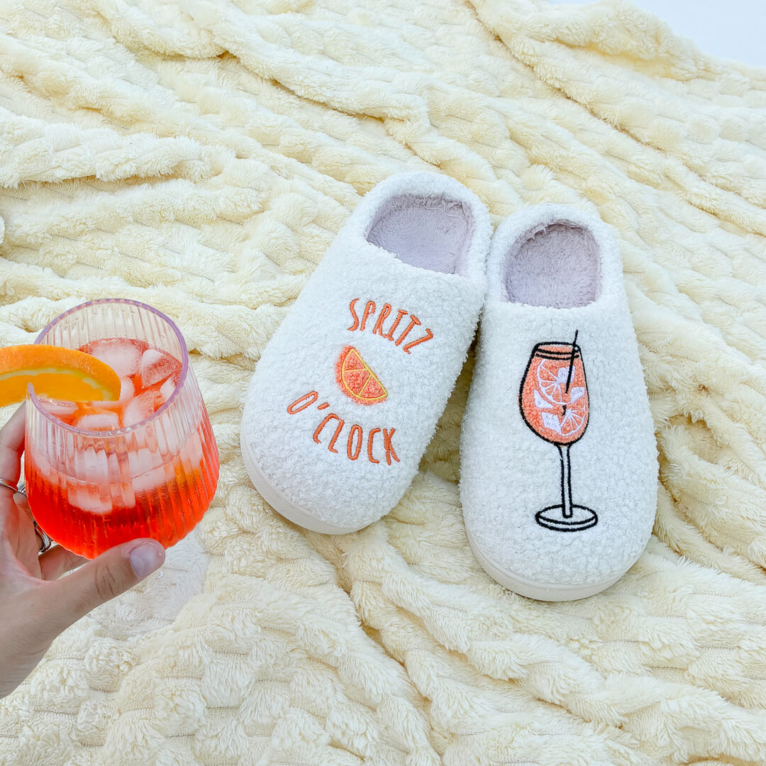 Soft indoor slippers with orange spritz drink design