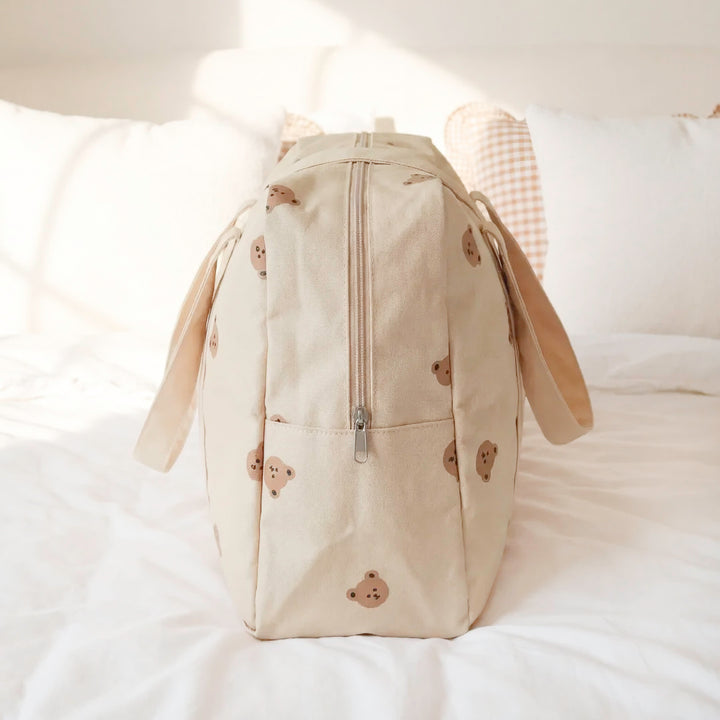 Beige duffle bag with bear print and neutral minimalist style