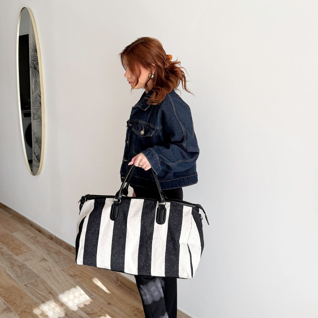 Travel bag with black and white stripe design