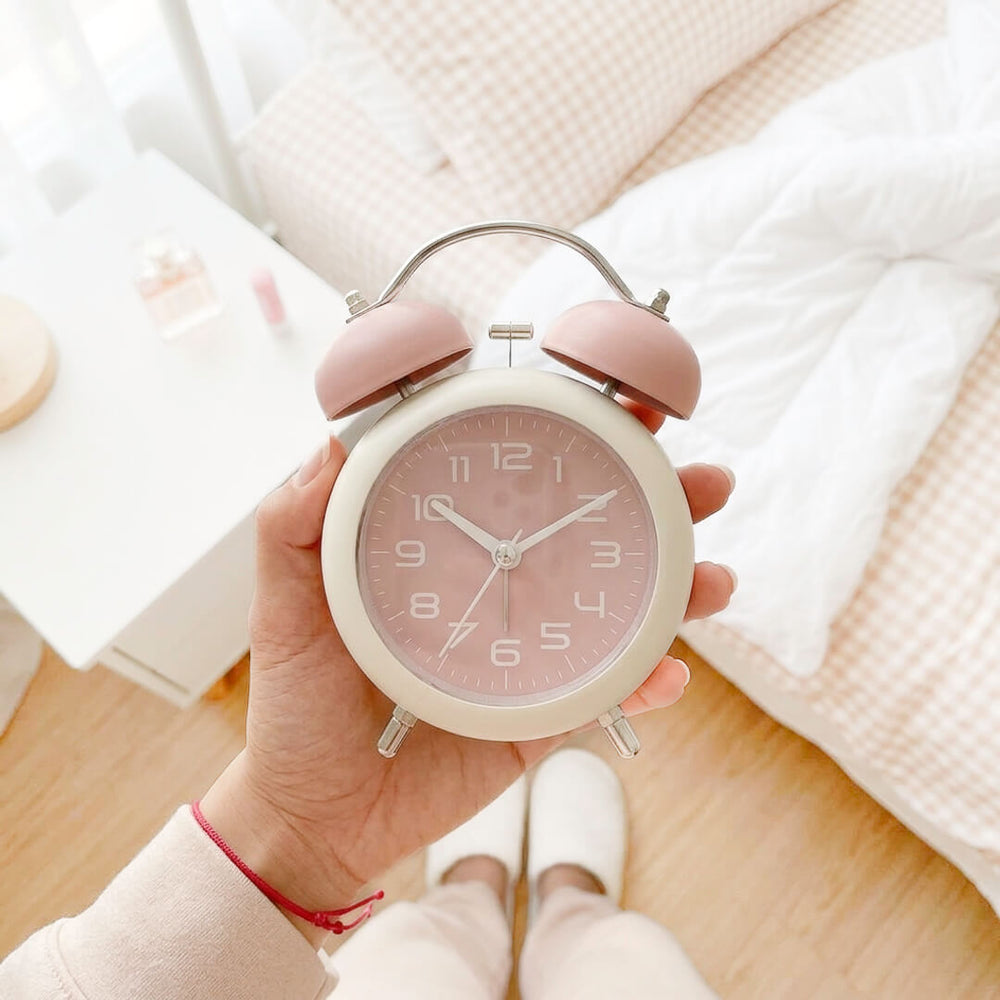 Vintage style pastel alarm clock with metal handle