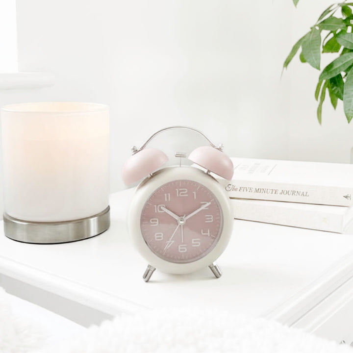 Small bedside alarm clock in soft pastel colors