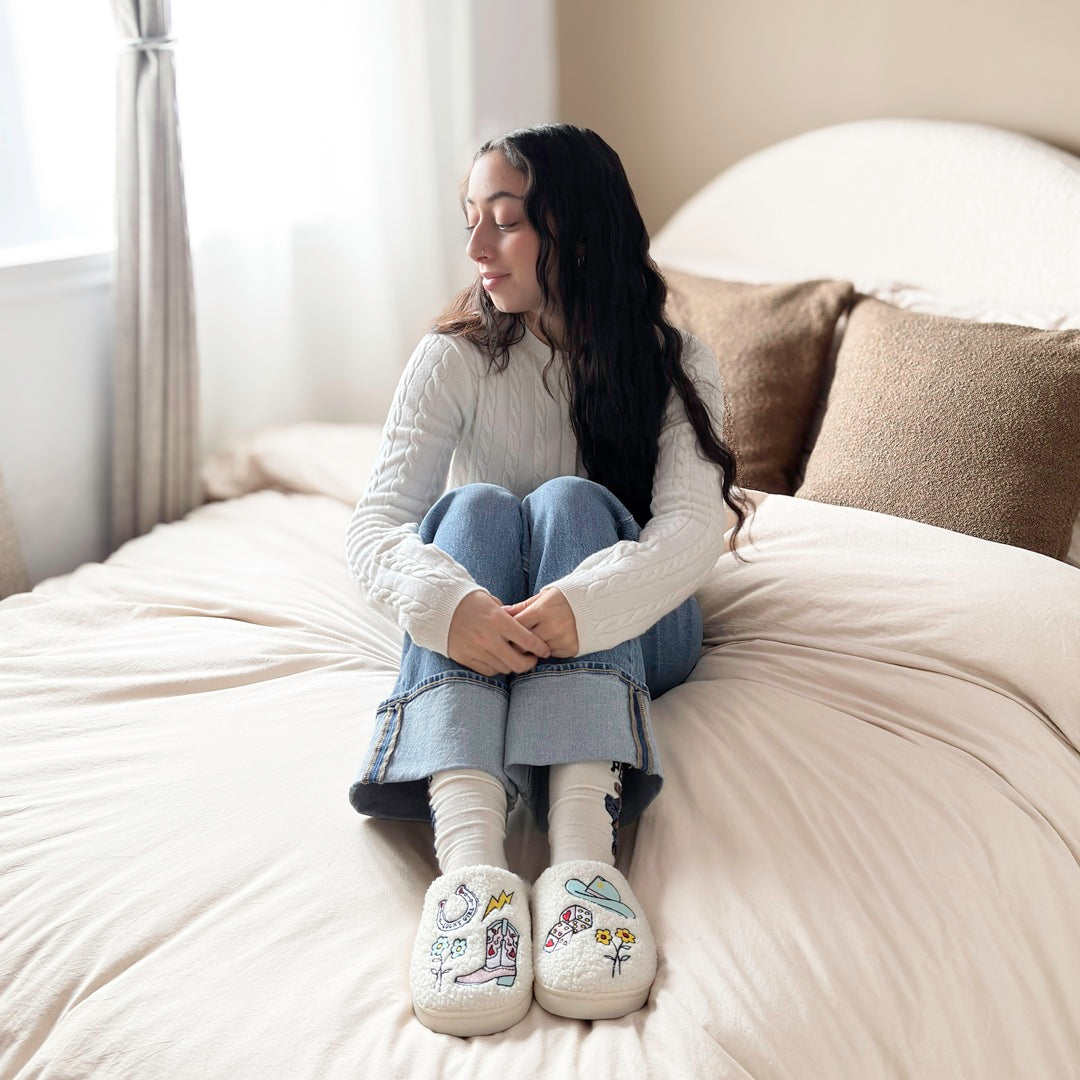 Soft plush house slippers with cowgirl icons