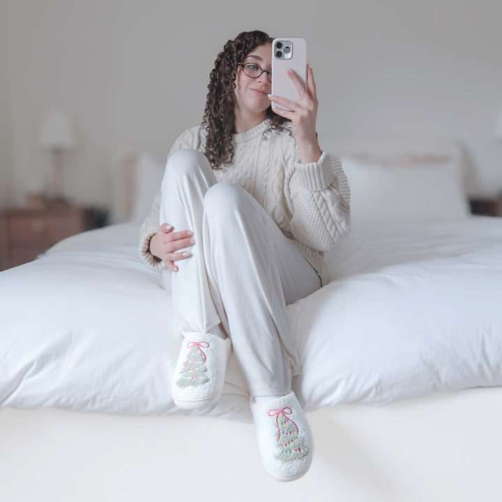 Holiday house slippers featuring a textured Christmas tree design