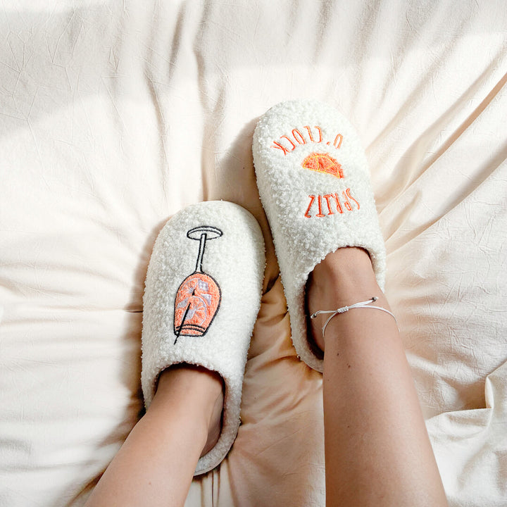 Soft white house slippers with orange slice detail