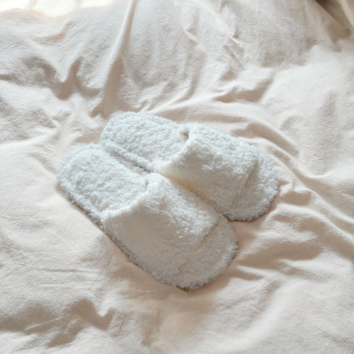 white plush slippers with cushioned slip-on style