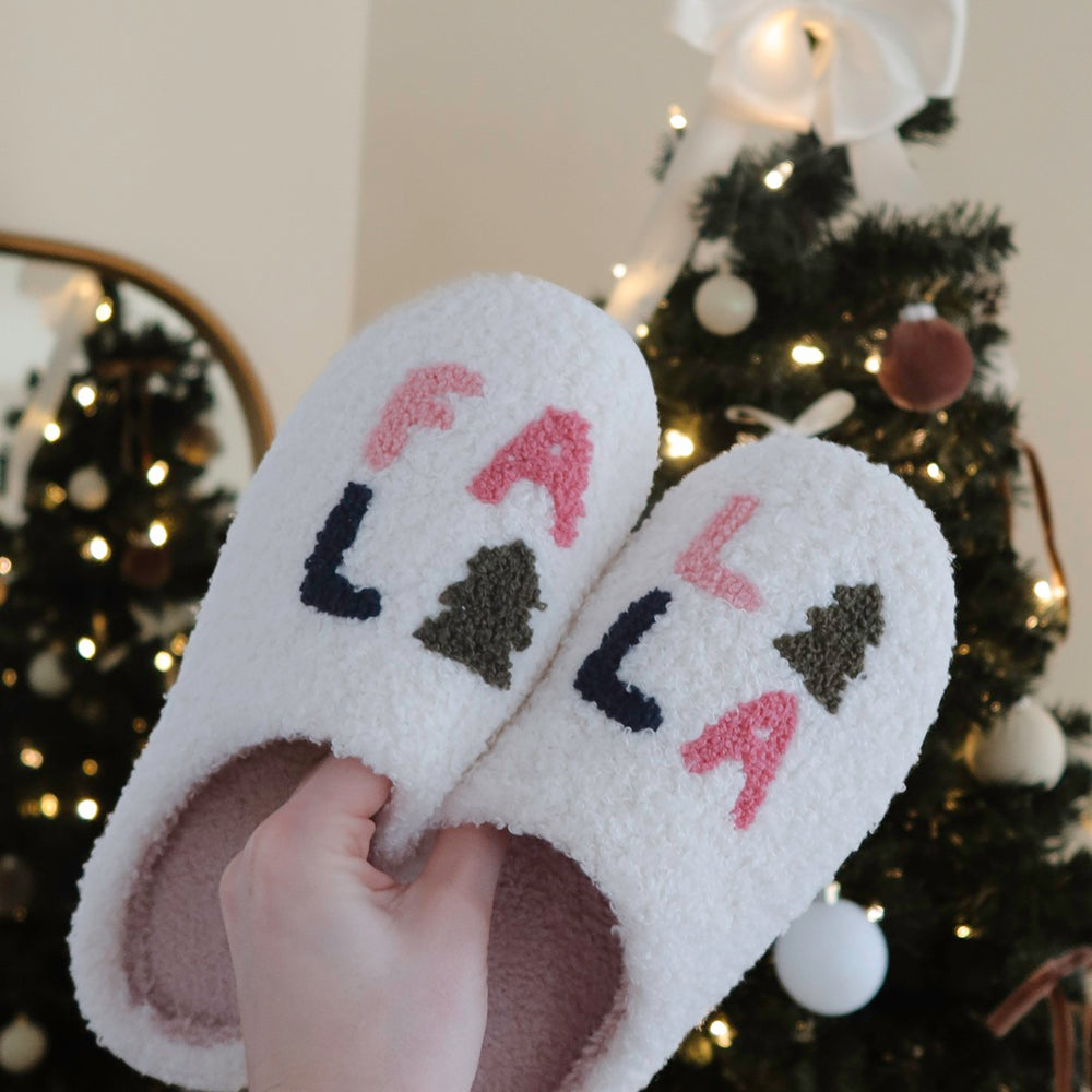 Cozy fuzzy Christmas slippers featuring “FA LA LA LA” holiday design