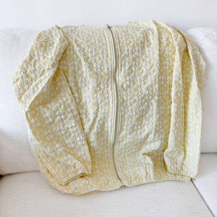 Lightweight-looking yellow jacket with raised floral texture