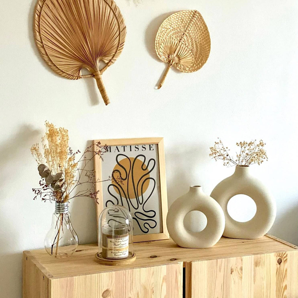 Bohemian decor with fans, vases, and art.